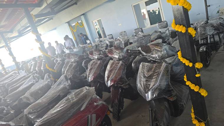 Excon scooters and basket e-bikes wrapped for delivery at the facility launch